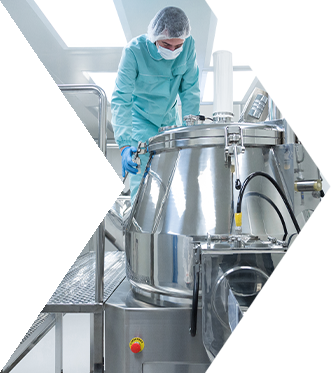 a PPE-clad individual in a factory
